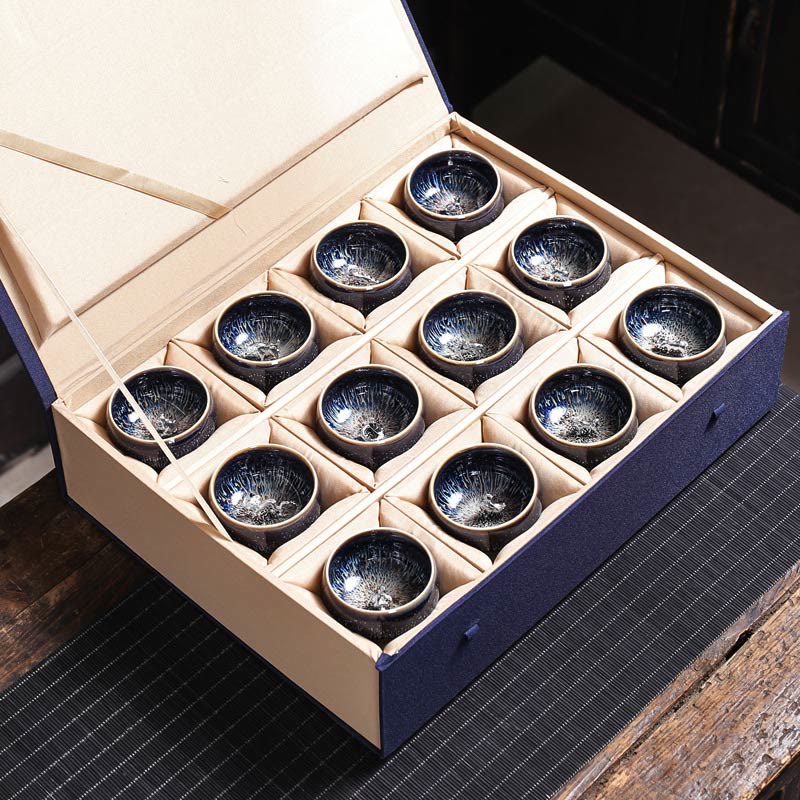 Jianzhan 12 Cup Set - six cups with lotus koi phoenix silver ornaments on textured mat
