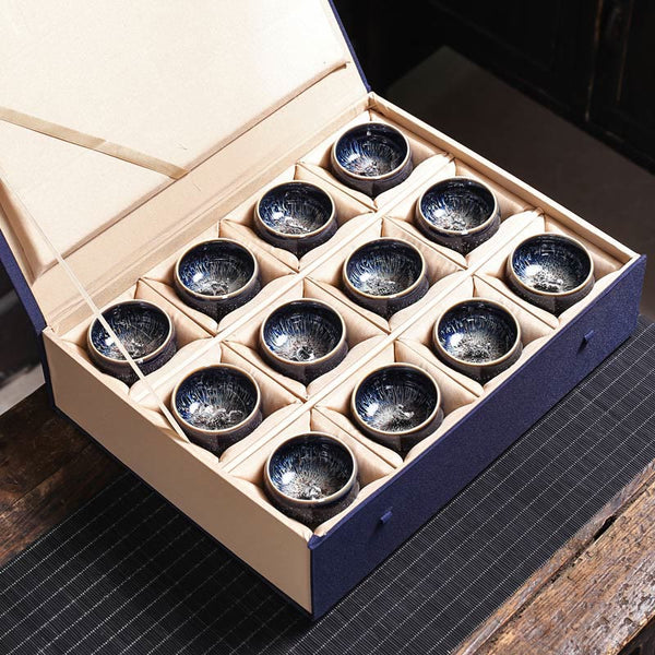 Jianzhan 12 Cup Set - six cups with lotus koi phoenix silver ornaments on textured mat