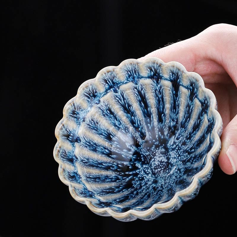 Jianzhan Lotus Ceramic Tea Cup held overhead revealing deep blue crystalline glaze interior