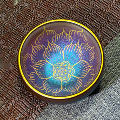 Jianzhan Lotus Flower Tea Cup – iridescent purple-blue glaze with gold lotus, woven fabric, ceramic teaware