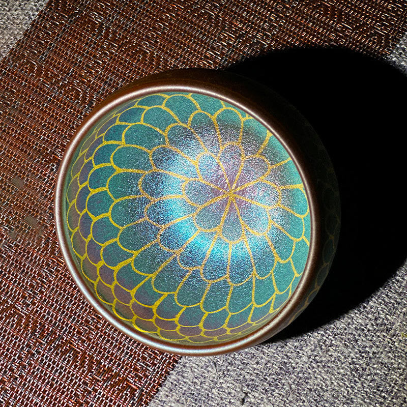 Lotus Flower Ceramic Tea Cup – teal and gold peacock feather pattern on woven mat, Jianzhan teaware