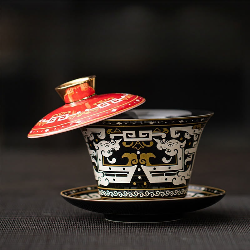 Dunhuang Ceramic Gaiwan Tea Set – Black and red taotie gaiwan with gold finial, dark mat, Museum Quality