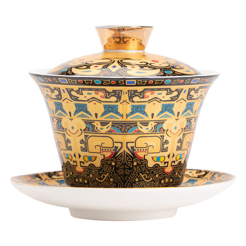 Dunhuang Ceramic Gaiwan Tea Set – Frontal gold taotie gaiwan on white, symmetrical bands, Studio Clean