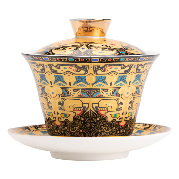 Dunhuang Ceramic Gaiwan Tea Set – Frontal gold taotie gaiwan on white, symmetrical bands, Studio Clean