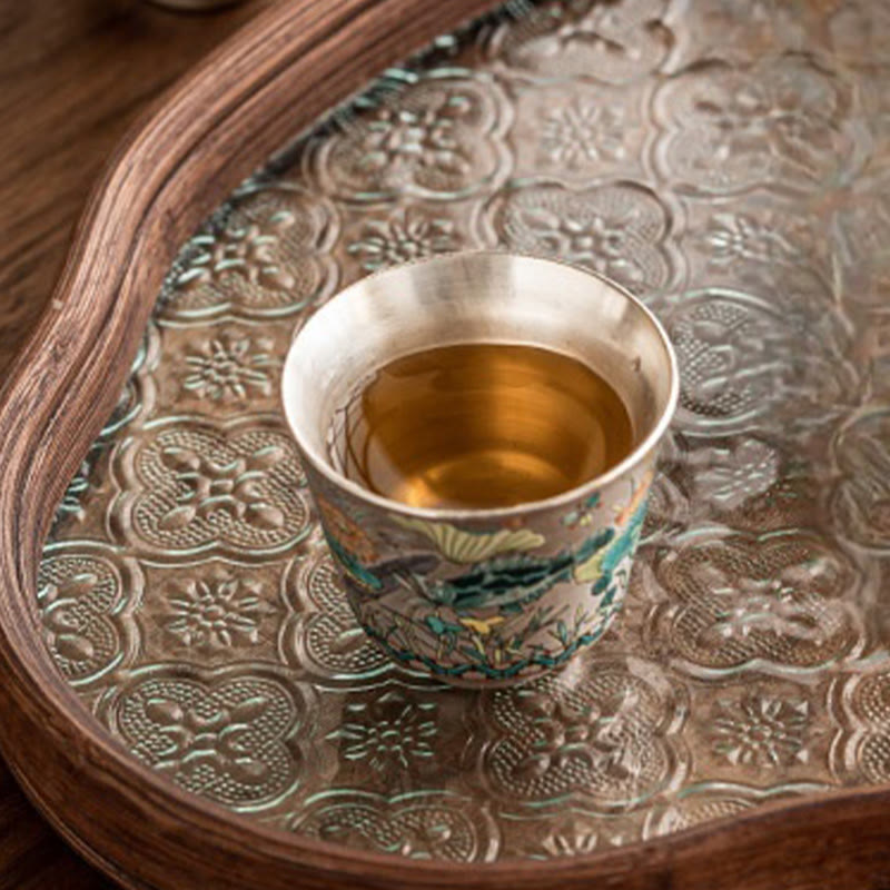 Fish Lotus Tea Cup – golden tea on aged silver tray with quatrefoil embossing, tea ceremony setting