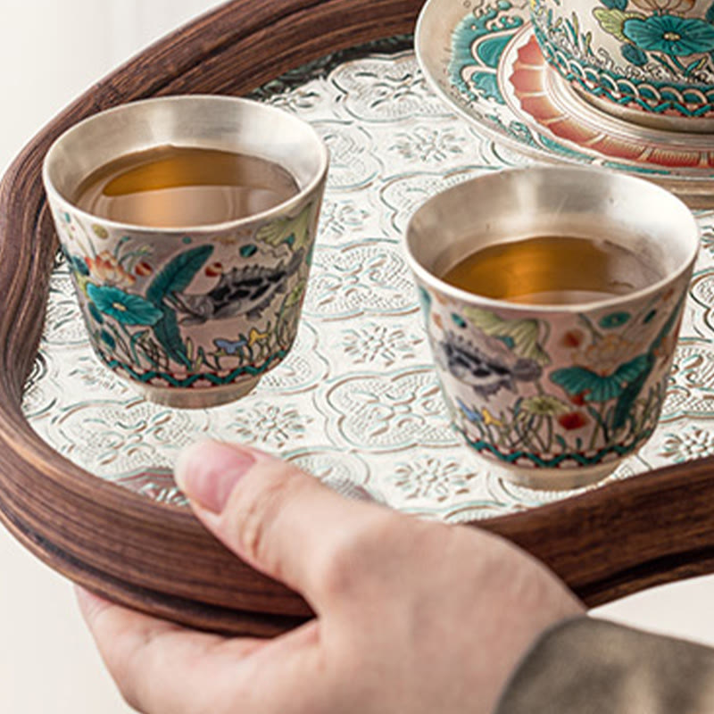 Fish Lotus Tea Cup – pair filled with tea on ornate silver tray with wood rim, ceramic gift set