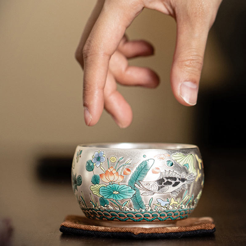 Ceramic Kung Fu Tea Cup Gift Set – Side view of fish-and-lotus cup on brown coaster, Shallow Focus