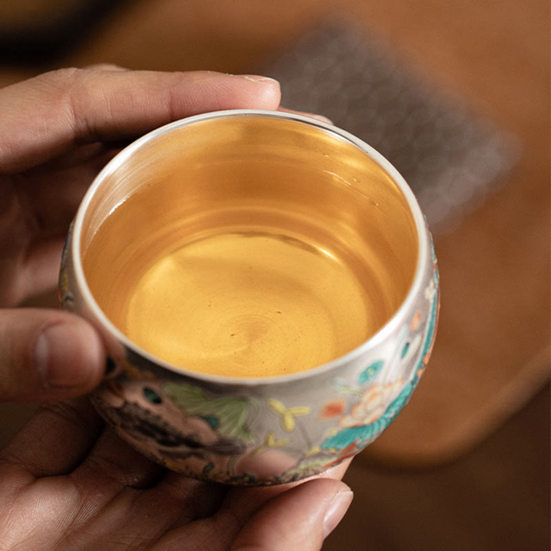 Ceramic Kung Fu Tea Cup Gift Set – Cup with tea held in hands, gold interior visible, Ritual Intimacy