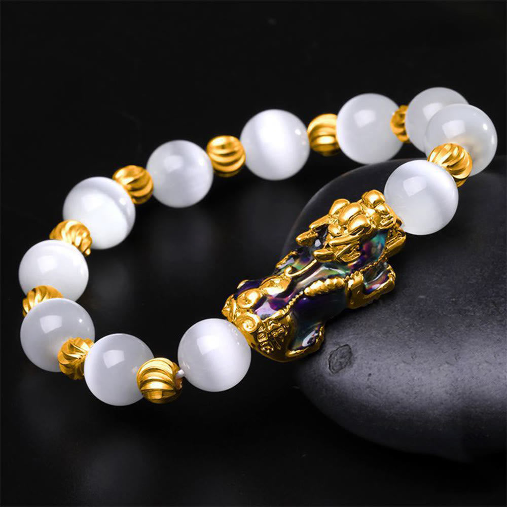 White cat's eye beads with gold spacers and enamel PiXiu on black stone