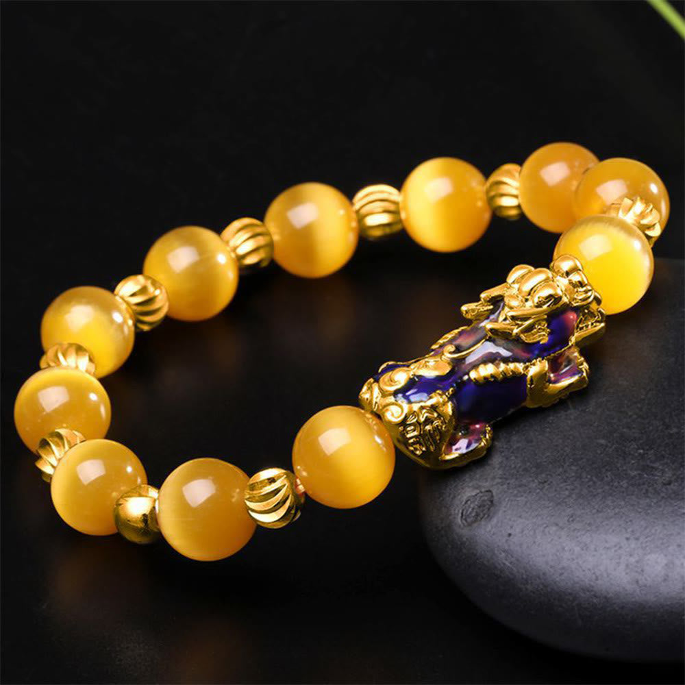 Yellow cat's eye beads with gold spacers and enamel PiXiu on black stone