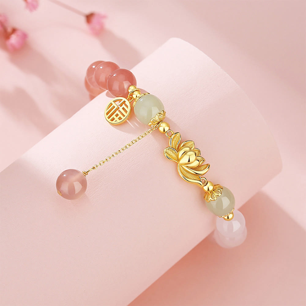 Agate & Hetian Jade Lotus Fu Bracelet – double happiness charm and gold lotus with jade beads on pink display, dangle bracelet