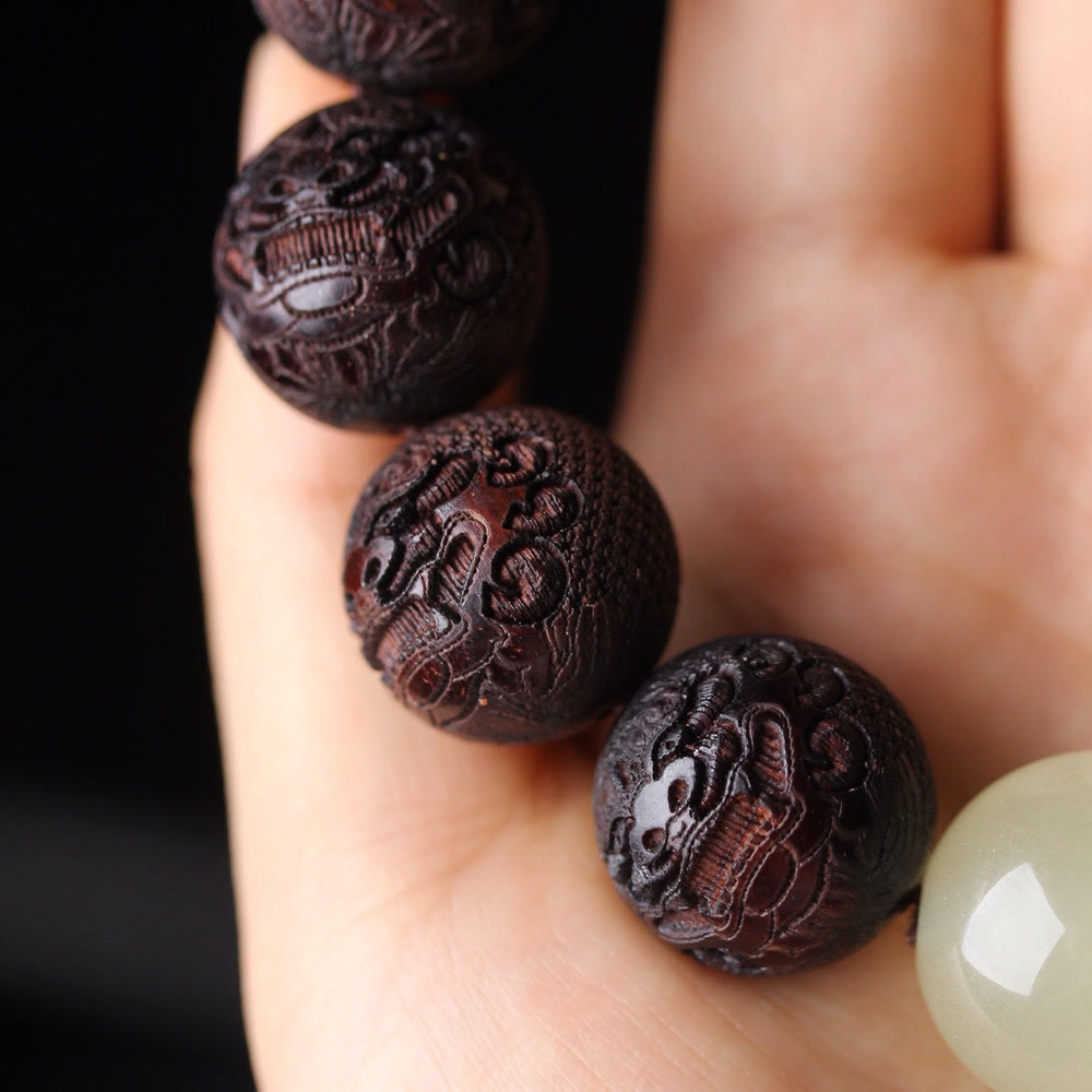Tibetan Rosewood Engraved Pixiu Warmth Healing Bracelet – three engraved beads with jade accent close-up, spiritual craft jewelry