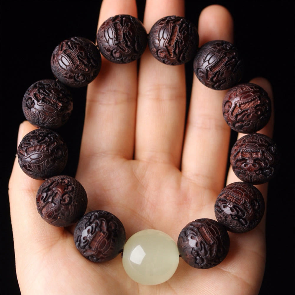 Tibetan Rosewood Engraved Pixiu Warmth Healing Bracelet – overhead palm view full circle dark wood beads, feng shui good luck