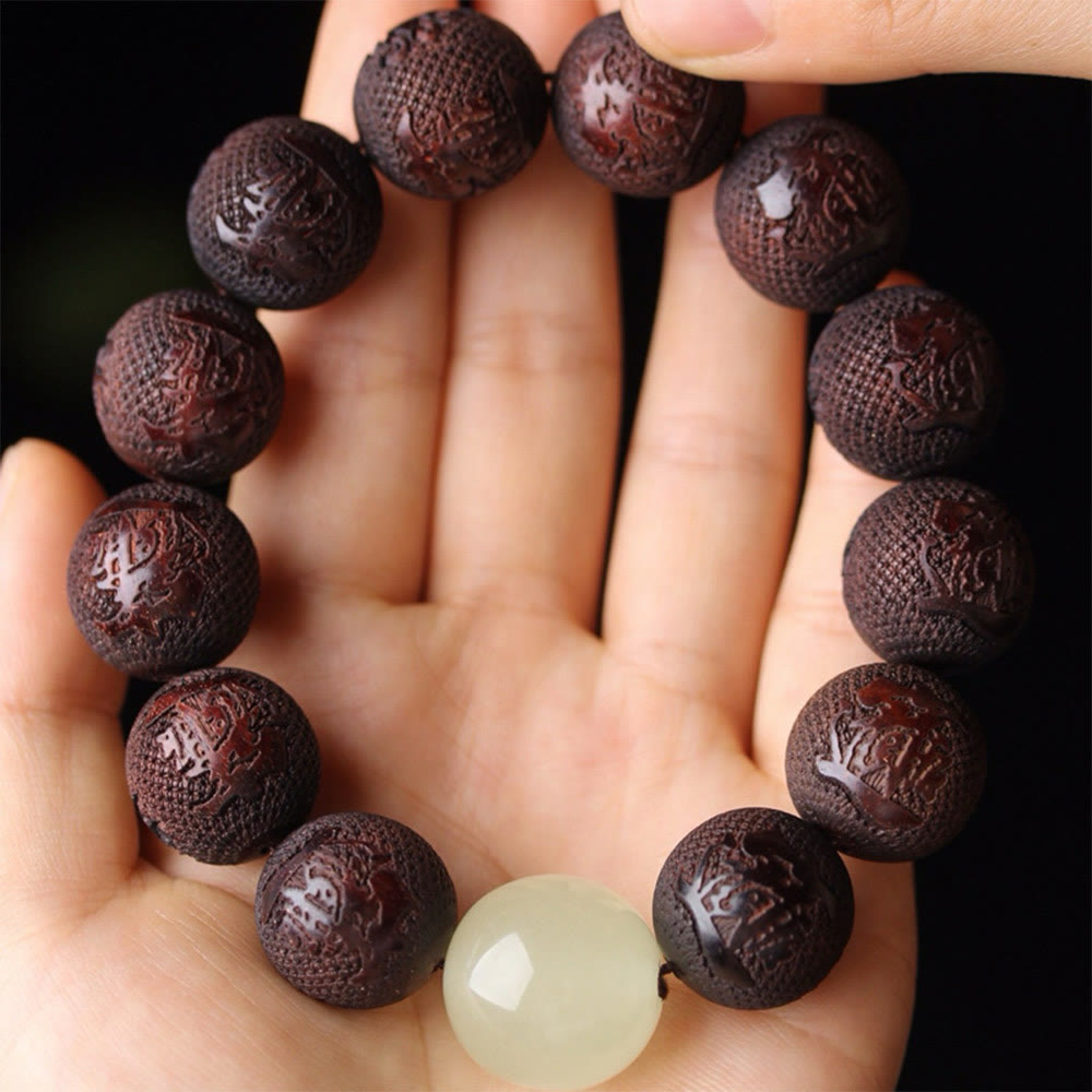 Tibetan Rosewood Engraved Pixiu Warmth Healing Bracelet – overhead palm view symbol engraved beads and jade, Tibetan mala style