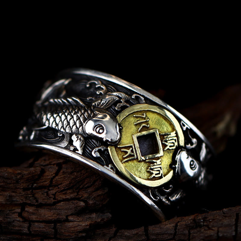 925 Silver Koi Fish Copper Coin Ring – three-quarter angle, twin koi around Chinese cash coin, wave motifs, dark wood