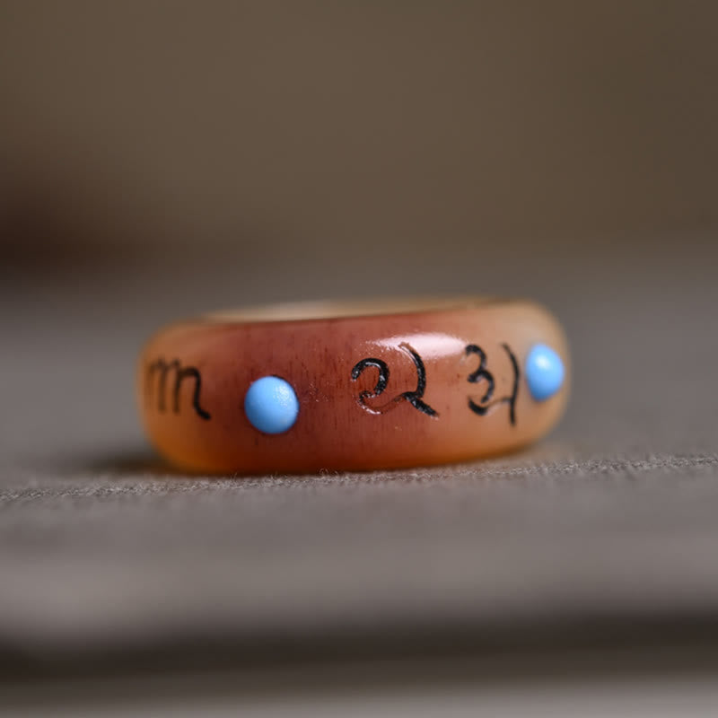 Camel Bone Om Mani Padme Hum Ring - Side profile of amber-bone band with turquoise dots and engraved mantra