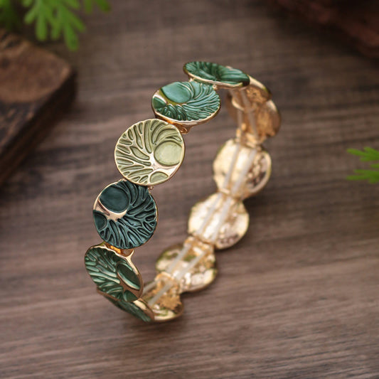Tree of Life Enamel Alloy Bracelet – green enamel on weathered wood with foliage, three-quarter elevated