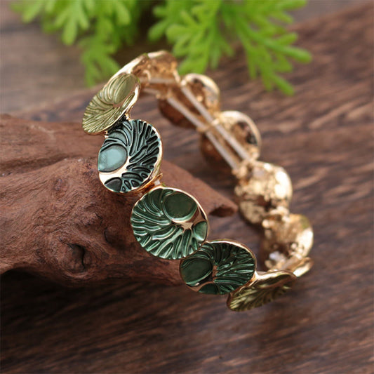Tree of Life Enamel Alloy Bracelet – green enamel on dark driftwood with foliage, low diagonal angle