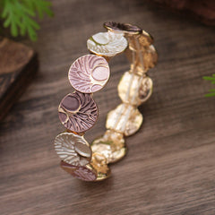 Tree of Life Enamel Alloy Bracelet – multicolor enamel standing on wood with fern, gradient earth tones