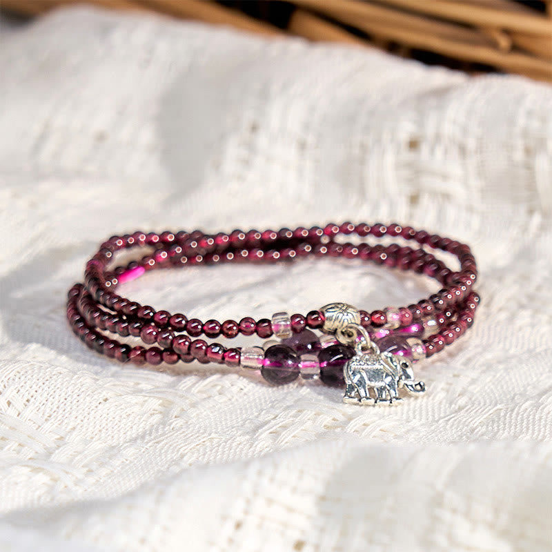 Natural Garnet PiXiu Elephant Abacus Lucky Bag Bracelet – garnet bracelet on white knit fabric with elephant charm, spiritual accessory