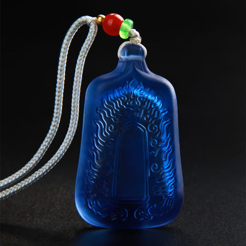 Medicine Buddha Liuli Necklace – pendant held in palm showing size and vibrant blue hue