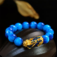 Blue sea willow beads with gold enamel PiXiu on black stone, gold leaf