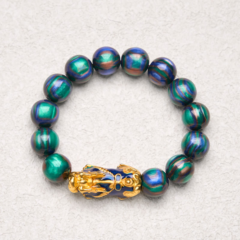 Green-blue sea willow bracelet on light textured surface, top view