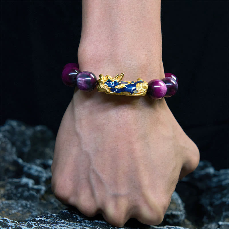 Purple sea willow bracelet worn on wrist against dark rocky background