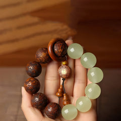 Sappan Wood Engraved Pixiu Fu Bracelet – hand held close-up with jade beads and Fu charm, feng shui wealth good luck