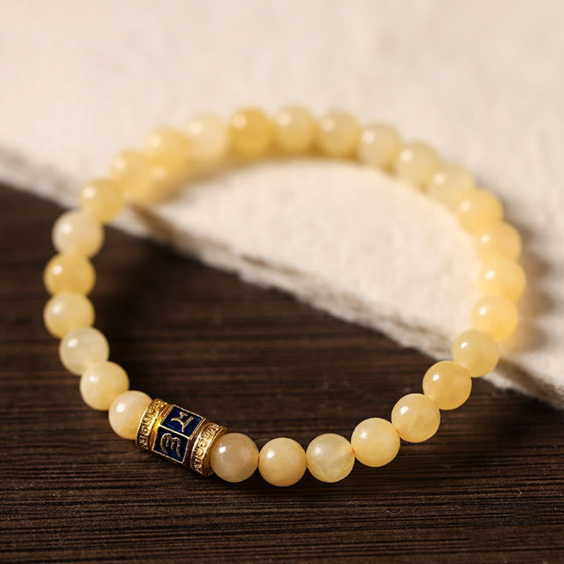 Om Mani Padme Hum Bracelet – Arc formation showcasing gold and blue enamel accent bead, natural stone beads