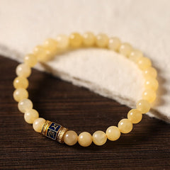 Om Mani Padme Hum Bracelet – Arc formation showcasing gold and blue enamel accent bead, natural stone beads