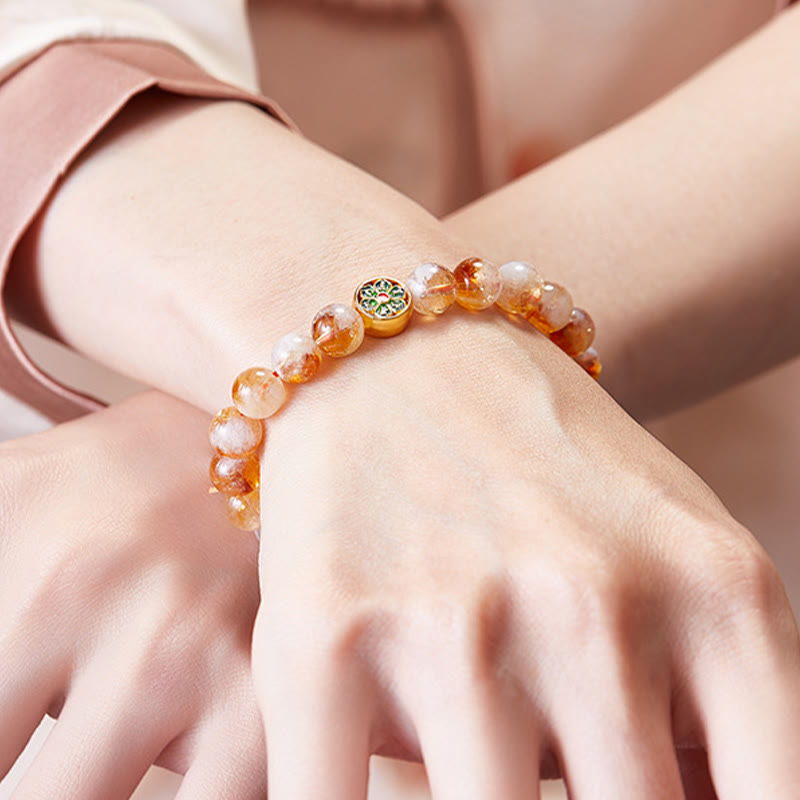 999 Sterling Silver Citrine Om Mani Padme Hum Bracelet – worn on wrist with elegant sheer sleeve, showing cloisonne charm centerpiece and warm honey citrine tones, feminine spiritual jewelry
