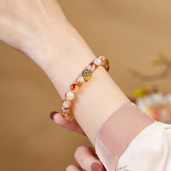 999 Sterling Silver Citrine Om Mani Padme Hum Bracelet – inner wrist close-up with bokeh floral background, highlighting marbled amber-white stone patterns and gold enamel medallion, artisan healing bracelet