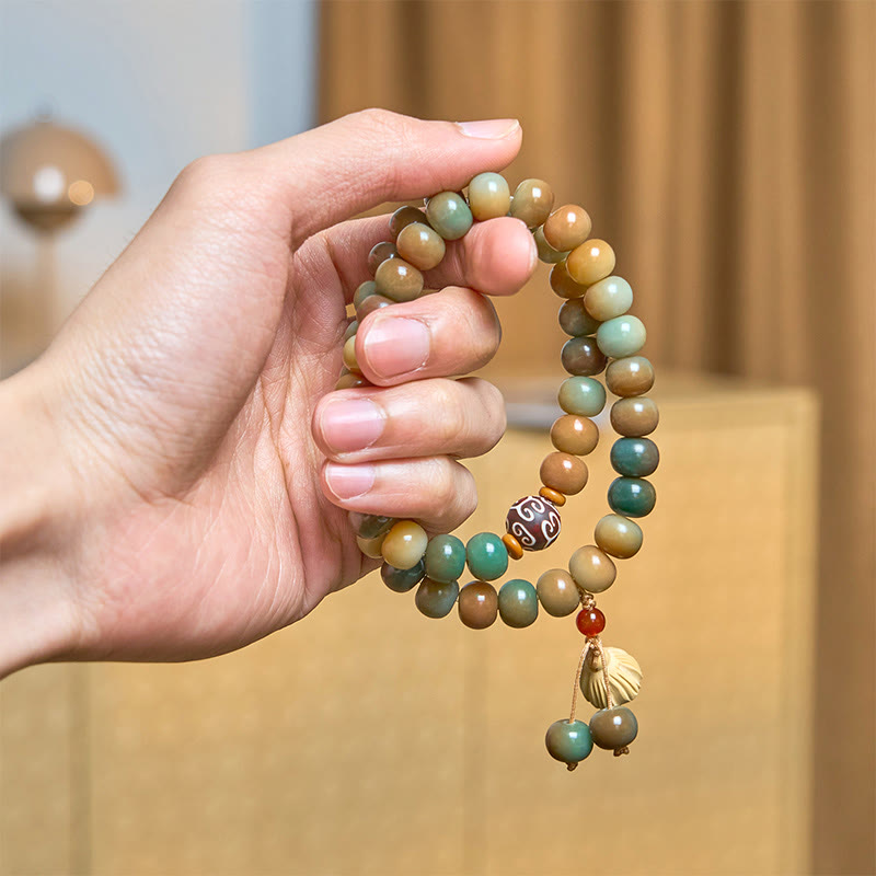 Colorful Bodhi Seed Lotus Pod Double Wrap Bracelet – hand-held view with shell charm & carved dzi bead, zen