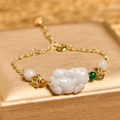 Natural Jade PiXiu Bracelet – carved white jade Pixiu gold chain on wood, warm light, good luck charm