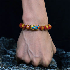 Red Agate PiXiu Color Change Bracelet Om Mani Padme Hum – worn on wrist over dark rocks, masculine protection accessory
