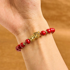 Cinnabar Pixiu Calm Bracelet – wrist view showing single strand red cinnabar beads with gold Pixiu charm, protection good luck bracelet