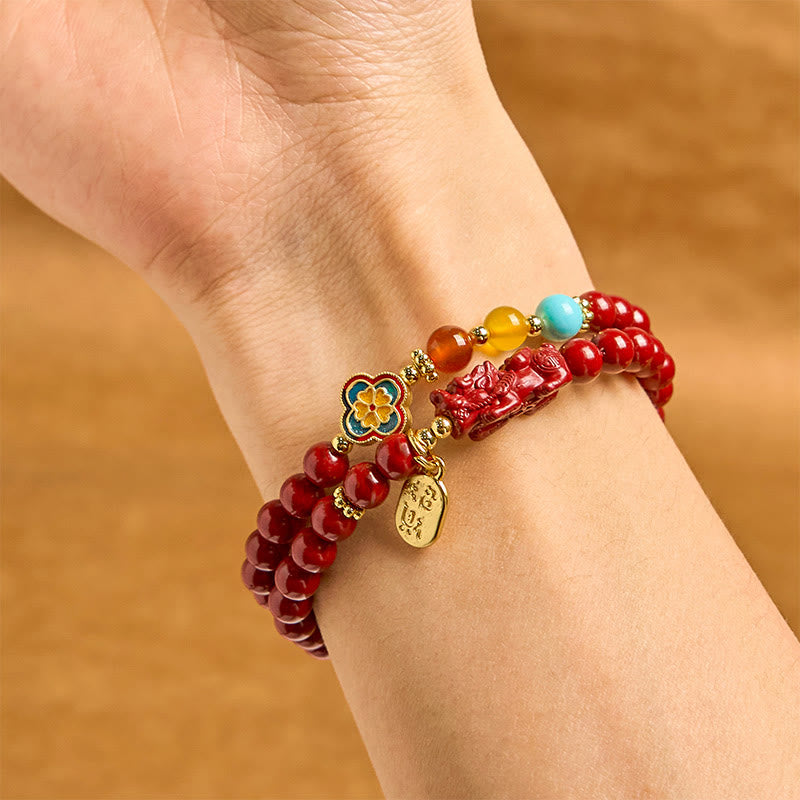 Cinnabar Pixiu Fu Bracelet – wrist view, double wrap red cinnabar beads with enamel flower, turquoise amber accents and Pixiu, wealth