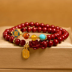 Cinnabar Pixiu Fu Bracelet – front view with amber background, double wrap red cinnabar beads, colorful accents and Pixiu charm, luck