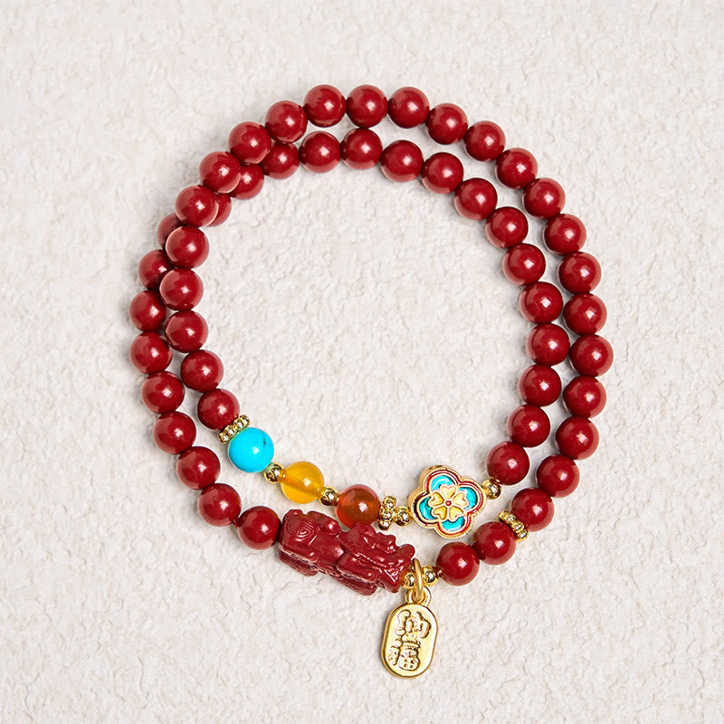 Cinnabar Pixiu Fu Bracelet – full circle on textured white background showing double wrap red cinnabar beads with Pixiu and flower, luck