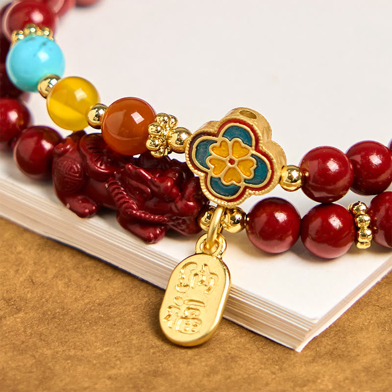 Cinnabar Pixiu Fu Bracelet – close-up of enamel flower, gold Fu tag, red Pixiu and turquoise amber beads, good fortune feng shui