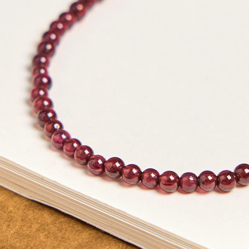 Garnet Pixiu Flower Bracelet – close-up of glossy 3mm garnet bead strands showing deep red purple color and smooth texture, good luck bracelet