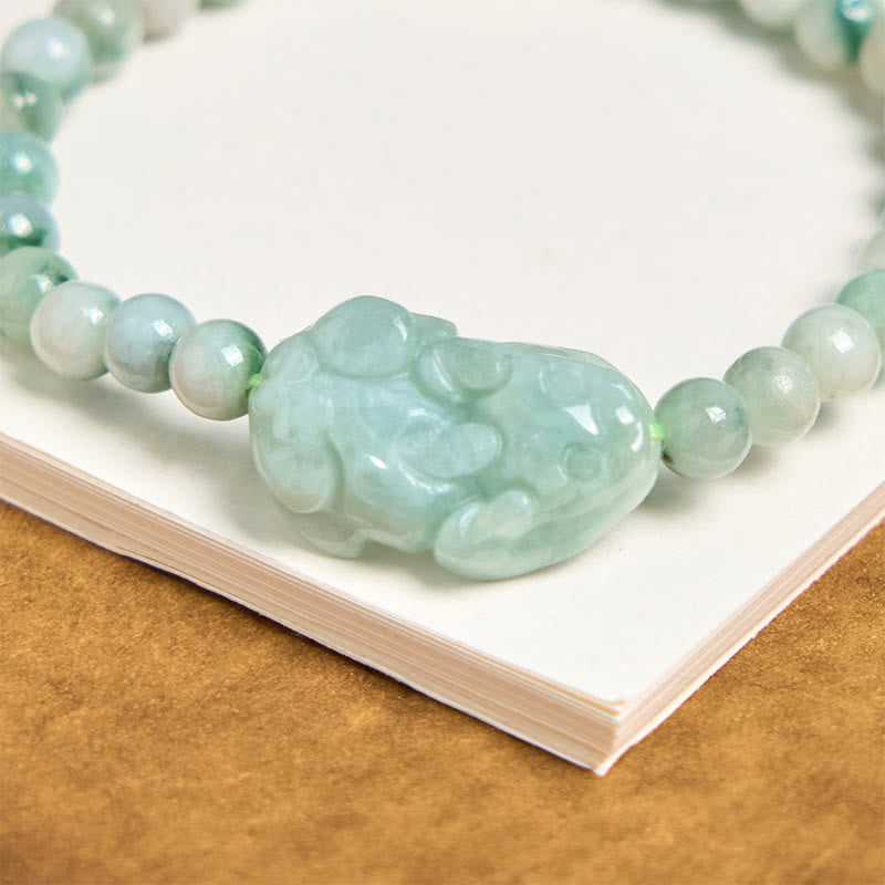 Natural Green Jade Pixiu Carved Luck Bead Bracelet – close-up of intricately carved green jade Pixiu centerpiece on white background, luck charm
