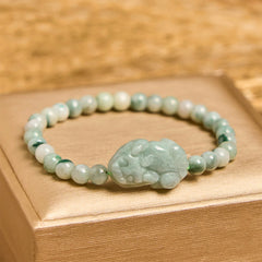 Natural Green Jade Pixiu Carved Luck Bead Bracelet – light green jade beads with carved Pixiu on gold gift box, feng shui wealth bracelet