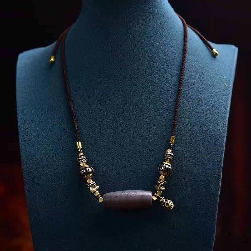 Tibetan Dzi Bead Agate Protection Pendant – worn on blue display bust, adjustable cord with mixed metal beads, spiritual n...