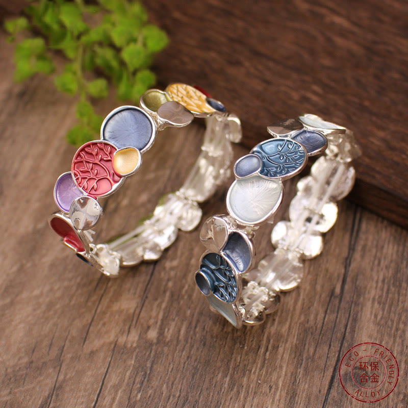 Tree of Life Alloy Elastic Bracelet – two bracelets on rustic wood with Eco-Friendly Alloy stamp, low angle