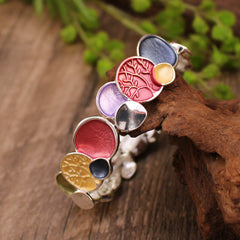 Tree of Life Alloy Elastic Bracelet – multicolor discs on driftwood with greenery, low three-quarter angle
