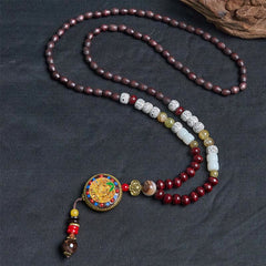 Tibetan Om Mani Padme Hum Necklace – Dark backdrop with wood prop, bodhisattva pendant and beaded tassel dangle