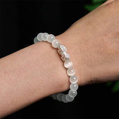 Cat's Eye 990 Sterling Silver Pixiu Positive Energy Bracelet – worn on wrist showing silver Pixiu detail and white beads, positive energy jewelry