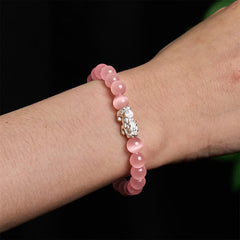 Cat's Eye 990 Sterling Silver Pixiu Positive Energy Bracelet – pink cat's eye bracelet worn on wrist with detailed silver Pixiu, feminine energy